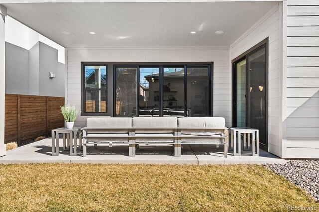 exterior space featuring fence and outdoor lounge area