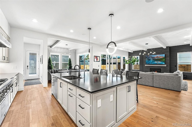 2255 S Monroe St, Denver, CO 80210 - kitchen with a sink, beamed ceiling, dark countertops, light wood-style flooring, and recessed lighting