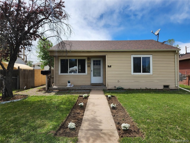 bungalow-style home with a front yard