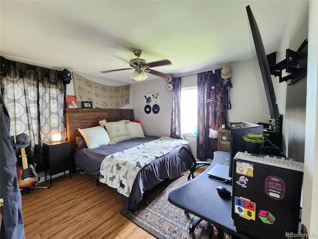 bedroom with ceiling fan and wood-type flooring