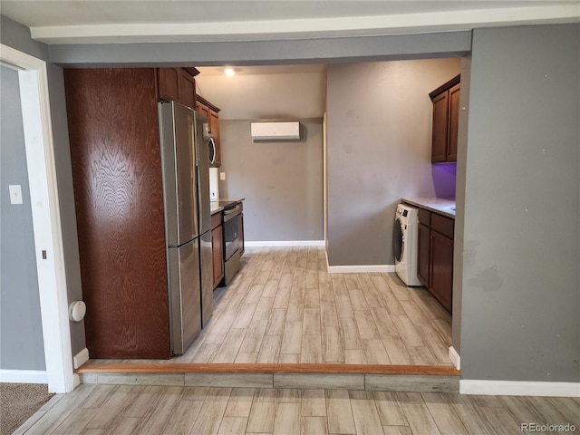 kitchen featuring dishwashing machine, stainless steel fridge, washer / dryer, and a wall mounted air conditioner