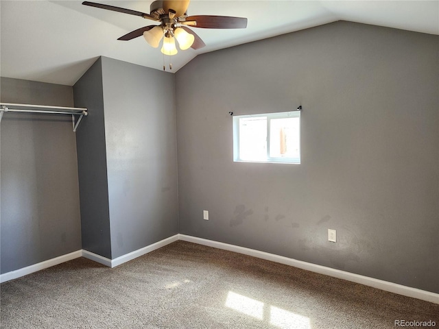 unfurnished bedroom with ceiling fan, a closet, carpet floors, and vaulted ceiling