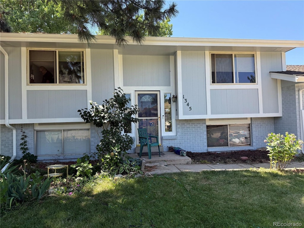 1345 Youngfield St, Golden, CO 80401 - view of front of house with brick siding and a front yard