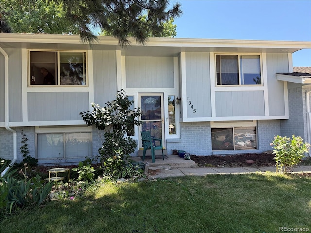 1345 Youngfield St, Golden, CO 80401 - view of front of house with brick siding and a front yard