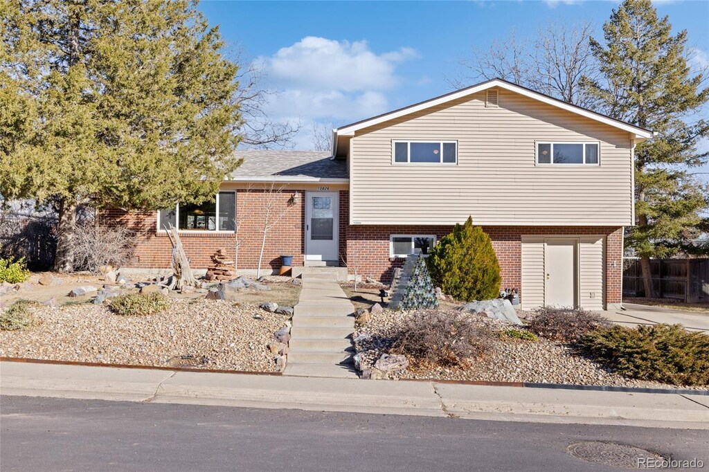 10826 Livingston Dr, Northglenn, CO 80234 - split level home featuring fence and brick siding