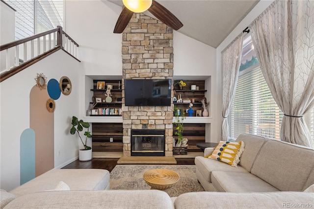 2249 Weatherstone Cir, Highlands Ranch, CO 80126 - living area with ceiling fan, vaulted ceiling, a fireplace, wood finished floors, and arched walkways