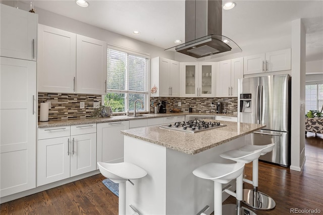 2249 Weatherstone Cir, Highlands Ranch, CO 80126 - kitchen featuring stainless steel appliances, island range hood, dark wood-style floors, white cabinetry, and recessed lighting