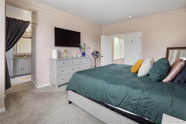 2249 Weatherstone Cir, Highlands Ranch, CO 80126 - bedroom featuring light colored carpet, a textured ceiling, and ensuite bathroom
