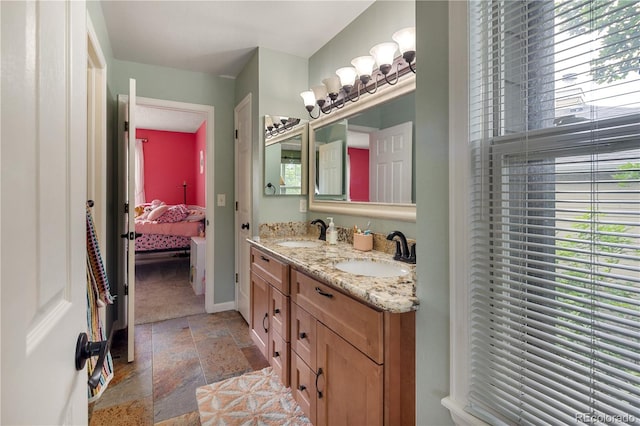 2249 Weatherstone Cir, Highlands Ranch, CO 80126 - ensuite bathroom featuring stone tile floors and double vanity