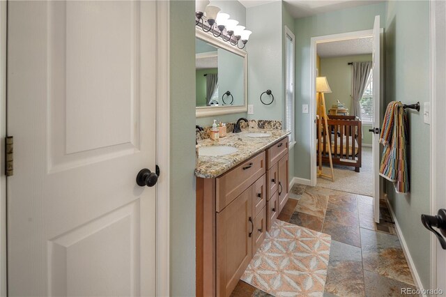 2249 Weatherstone Cir, Highlands Ranch, CO 80126 - full bath with stone tile flooring and double vanity