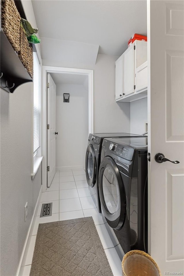 2249 Weatherstone Cir, Highlands Ranch, CO 80126 - laundry area featuring cabinet space, washing machine and dryer, and light tile patterned floors
