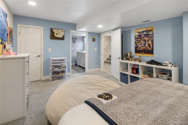 2249 Weatherstone Cir, Highlands Ranch, CO 80126 - bedroom with light colored carpet, recessed lighting, and connected bathroom