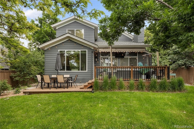 2249 Weatherstone Cir, Highlands Ranch, CO 80126 - rear view of house featuring a wooden deck, roof with shingles, and outdoor dining space