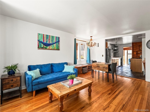 living area with a chandelier and light wood finished floors