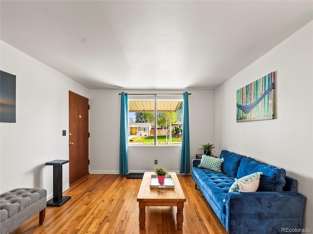 living area with light wood-style flooring and baseboards