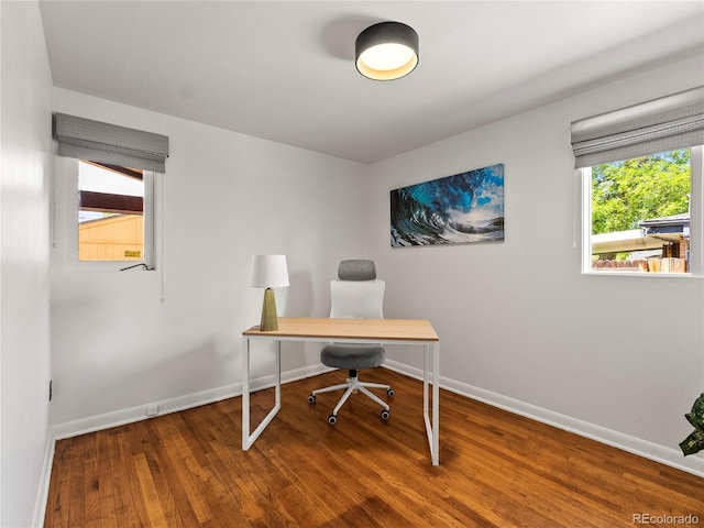 office space featuring baseboards and wood finished floors