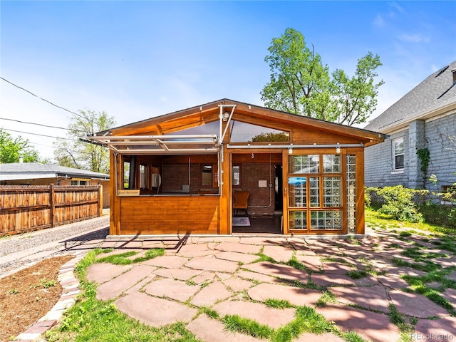 rear view of property featuring fence