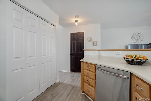 kitchen featuring dishwasher, light countertops, light wood-style floors, and brown cabinets