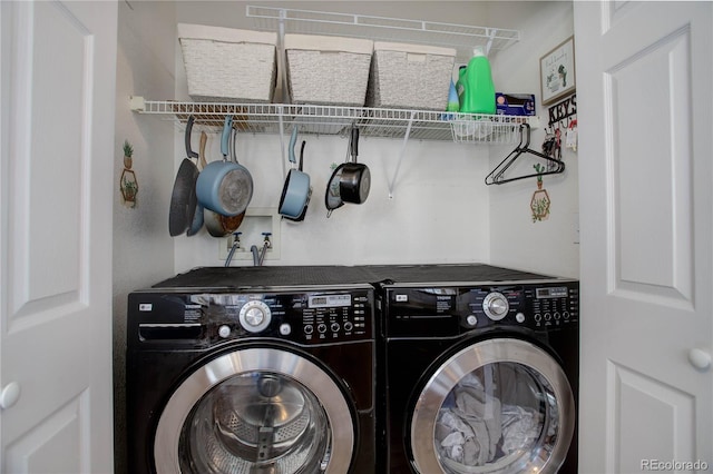 clothes washing area with washer and dryer and laundry area