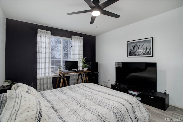 bedroom with a ceiling fan and wood finished floors