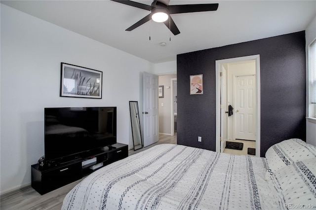 bedroom with baseboards, a ceiling fan, and light wood finished floors