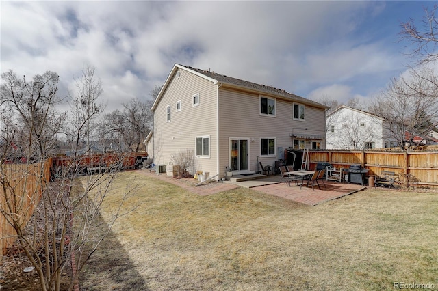 rear view of house featuring a patio area, a fenced backyard, and a yard