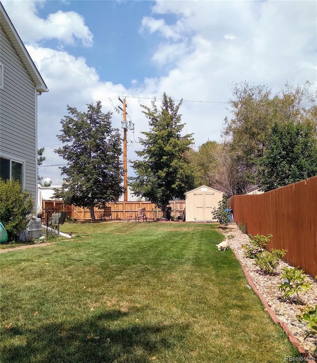 view of yard with a fenced backyard, a storage shed, and an outdoor structure