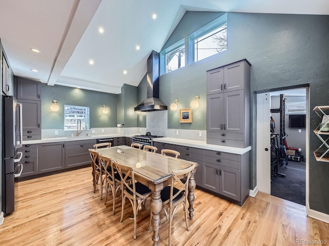 dining area featuring recessed lighting, high vaulted ceiling, and light wood-style flooring