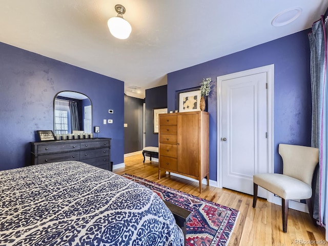 bedroom featuring wood finished floors and baseboards