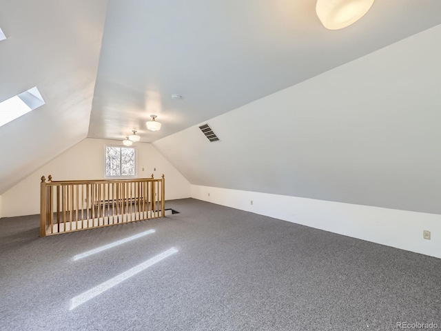 bonus room with vaulted ceiling with skylight, visible vents, and carpet floors