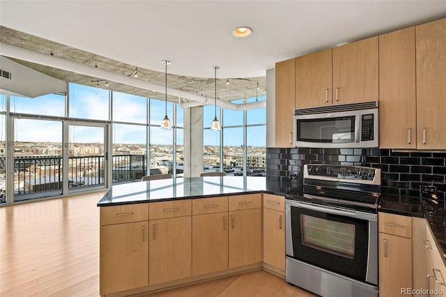 kitchen featuring stainless steel appliances, light hardwood / wood-style floors, kitchen peninsula, light brown cabinetry, and hanging light fixtures