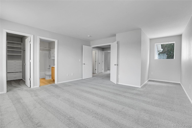 7977 S Kittredge St, Englewood, CO 80112 - unfurnished bedroom featuring carpet floors, a walk in closet, and connected bathroom