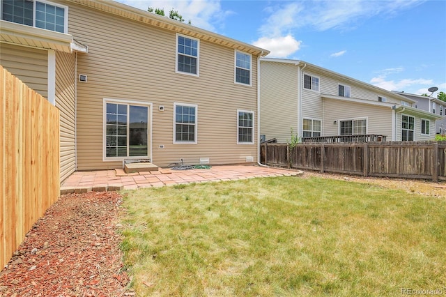 7977 S Kittredge St, Englewood, CO 80112 - back of property featuring a fenced backyard and a patio area