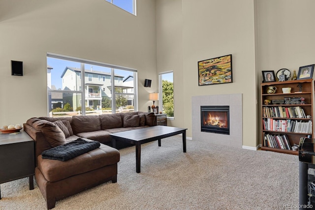 living room with light colored carpet, a fireplace, and a healthy amount of sunlight