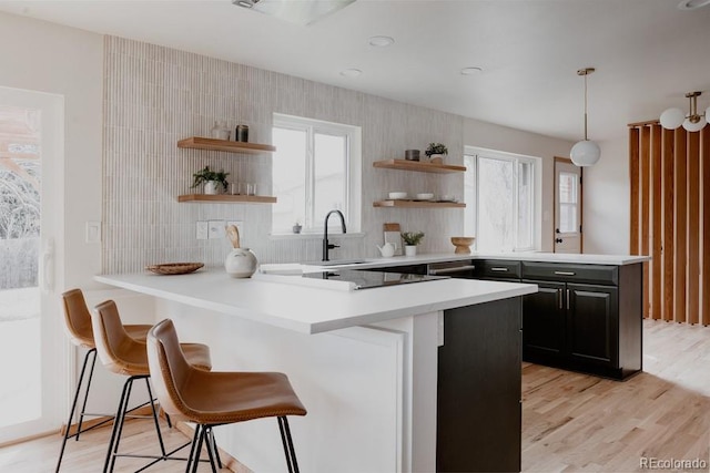 3400 Moore St, Wheat Ridge, CO 80033 - kitchen featuring open shelves, a peninsula, light countertops, and a breakfast bar