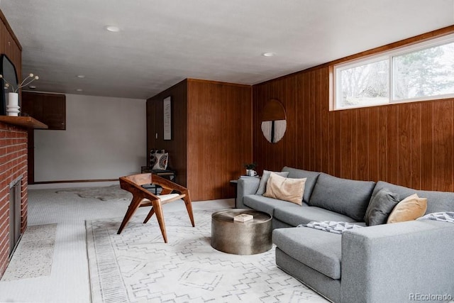 3400 Moore St, Wheat Ridge, CO 80033 - living room with wood walls, a fireplace, light carpet, and baseboards