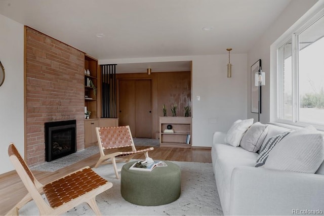 3400 Moore St, Wheat Ridge, CO 80033 - living area with a fireplace, built in shelves, and light wood-type flooring