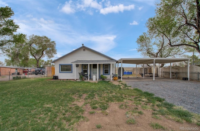 2615 Lambert Ave, Pueblo, CO 81003 - back of house with a porch and gravel driveway