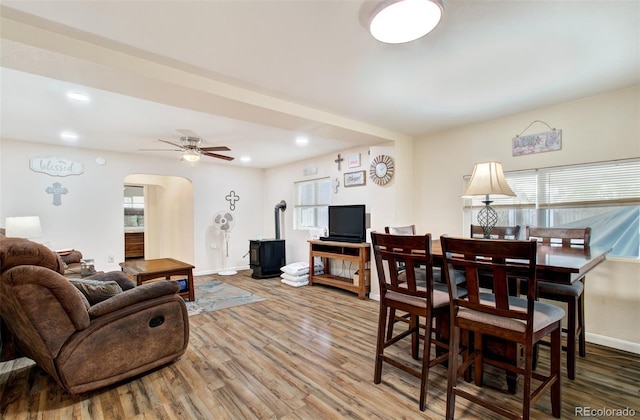 2615 Lambert Ave, Pueblo, CO 81003 - dining room with arched walkways, wood finished floors, ceiling fan, a wood stove, and recessed lighting