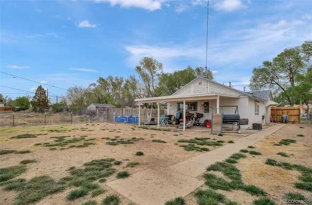 2615 Lambert Ave, Pueblo, CO 81003 - back of property with a fenced backyard, a patio, and stucco siding