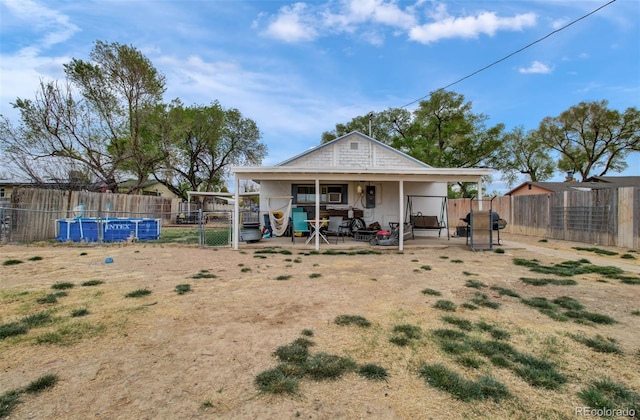 2615 Lambert Ave, Pueblo, CO 81003 - back of house featuring a fenced backyard, a gate, and a patio area