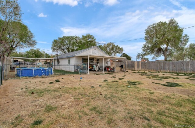 2615 Lambert Ave, Pueblo, CO 81003 - fenced backyard featuring a patio area