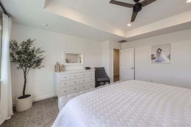 carpeted bedroom with recessed lighting, baseboards, ceiling fan, and a raised ceiling