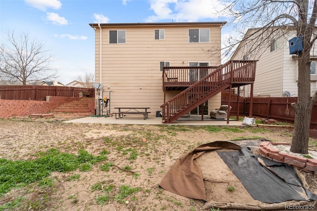 back of house featuring a patio, stairway, a fenced backyard, and a deck