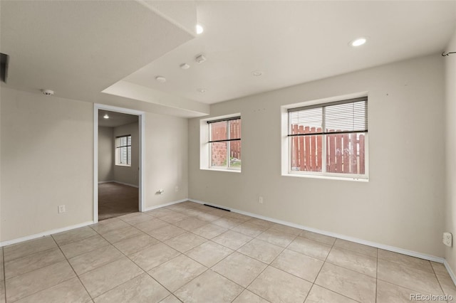 spare room featuring baseboards, recessed lighting, and light tile patterned flooring