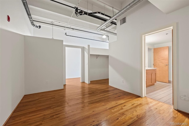 unfurnished room with wood-type flooring