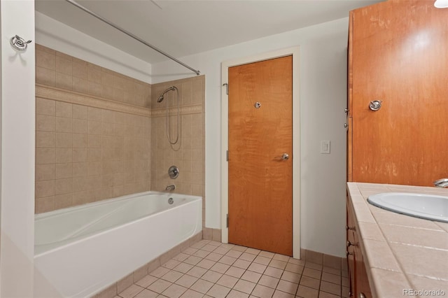 bathroom featuring tile patterned floors, tiled shower / bath combo, and vanity