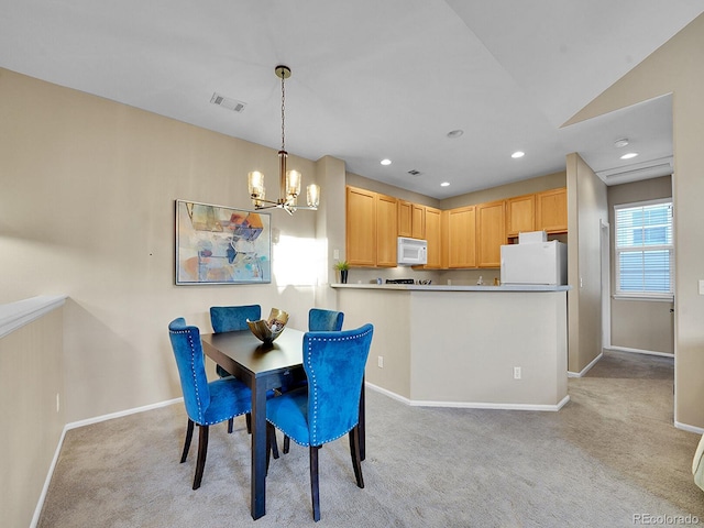 carpeted dining space with a notable chandelier