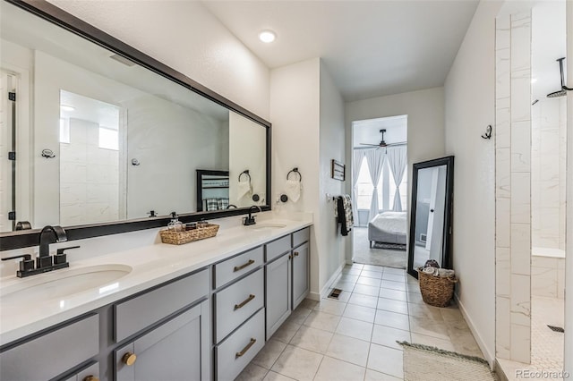 bathroom with tiled shower, vanity, and tile patterned floors