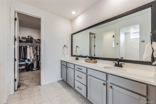 bathroom with tile patterned floors, vanity, and walk in shower